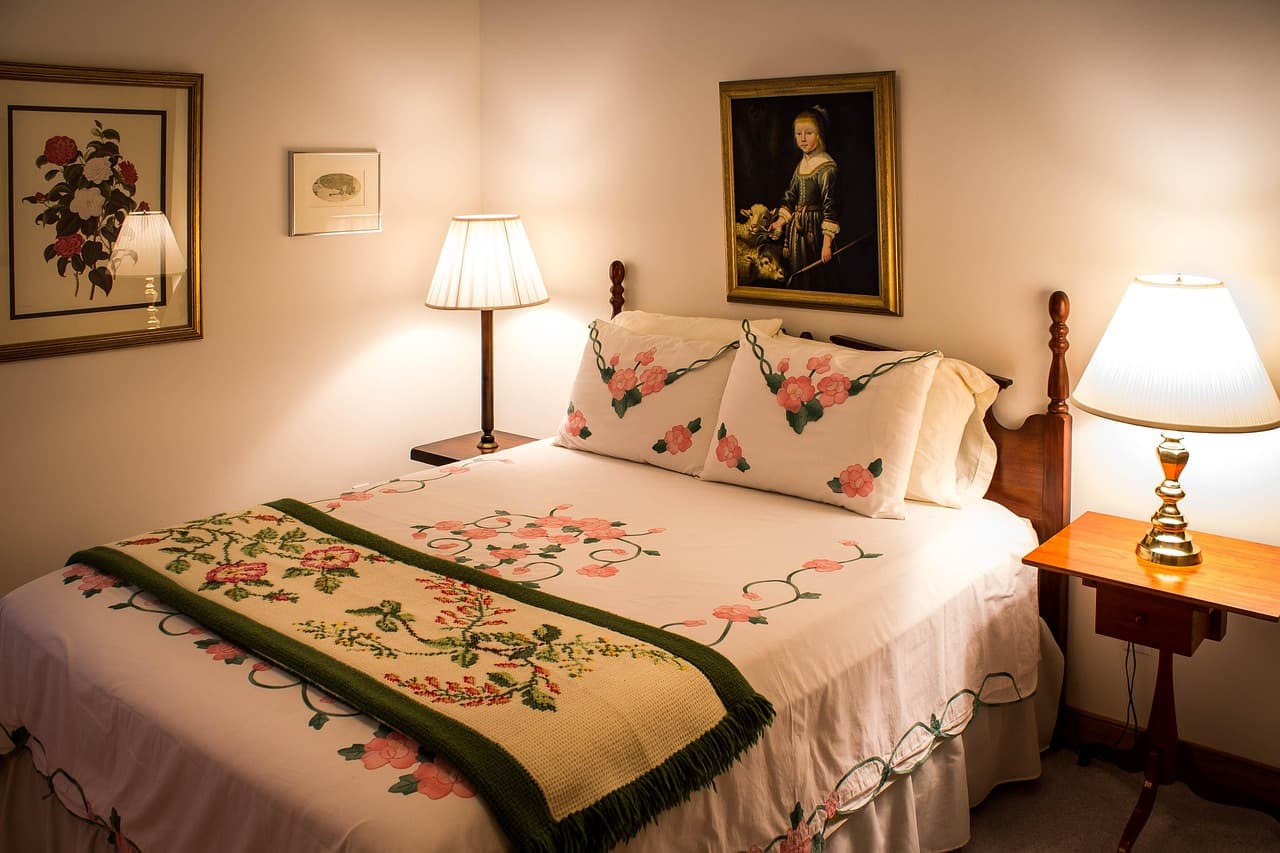 A made guest bedroom with layered linens and a quiet, restful feel