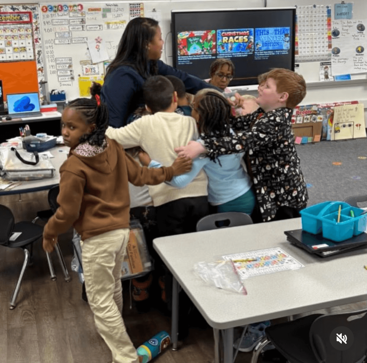 Students gathering around their teacher during a hands-on classroom session